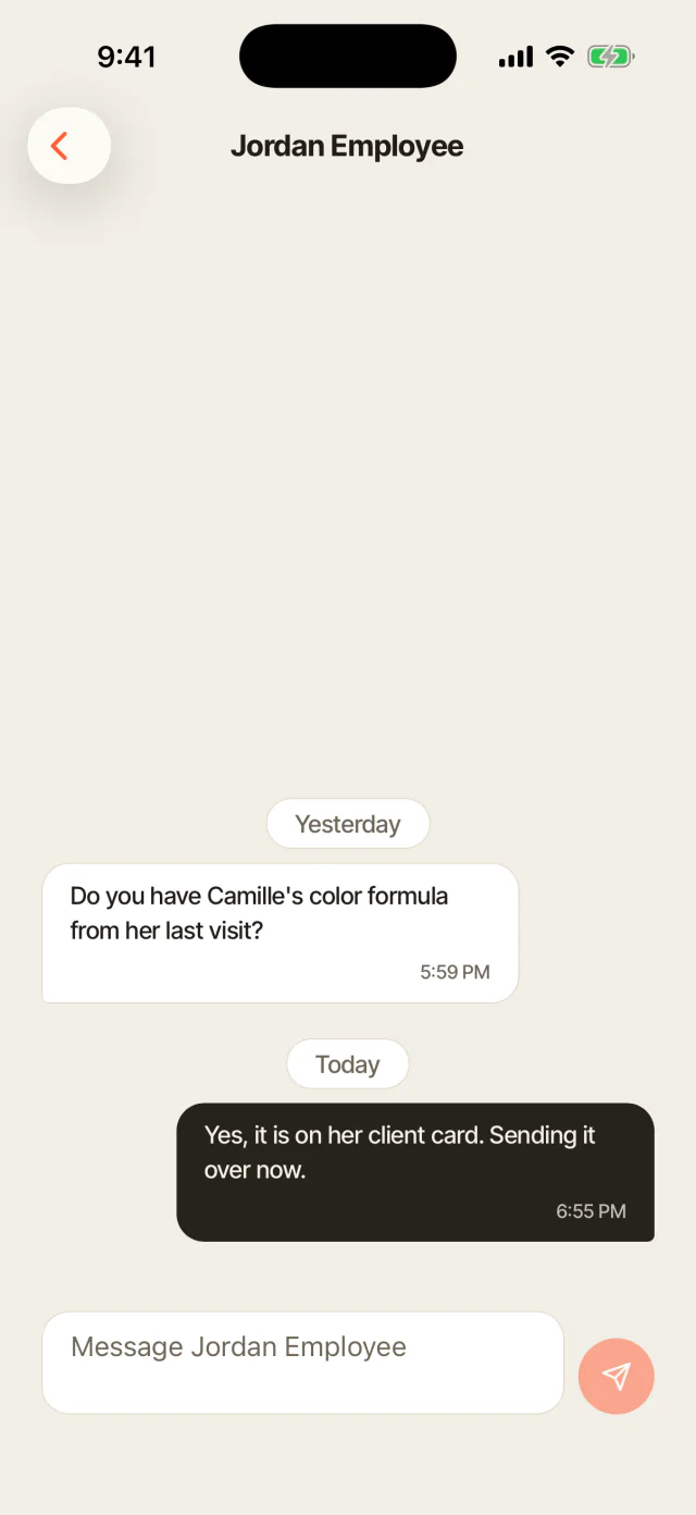 A client message thread open on a phone, answered between appointments.